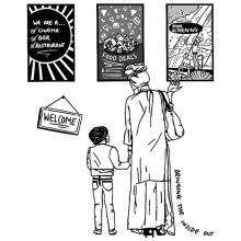 Adult and child stand looking at posters and a welcome sign