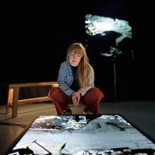 Amy Rose, Undershed Curator is peering down at a screen showing FRAMERATE: Pulse of the Earth