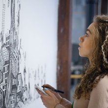 Jasmine Thompson working on one of her murals in the Pervasive Media Studio