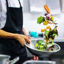 Photo of a chef cleaning salad at Watershed
