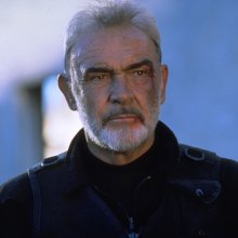 A still from The Rock. A man (Sean Connery), his face bruised and bloodied, stares into the middle distance, his brow furrowed.