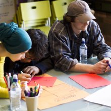 Three creatives collaborating at a workshop
