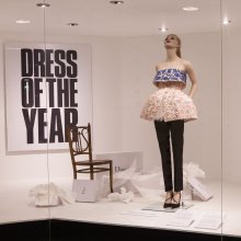Photo of a fashion model in a shop window advertising Dress Of The Year Collection