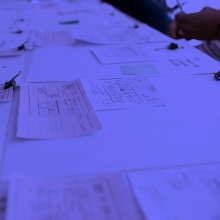Photo overlaid with blue of a table of planning drawings