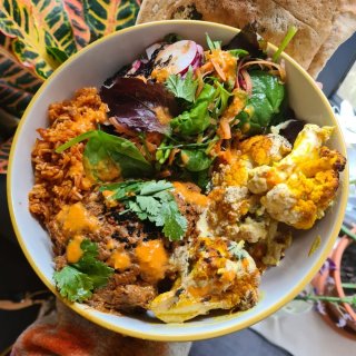 A bowl of brightly coloured plant based food from Houria Bristol