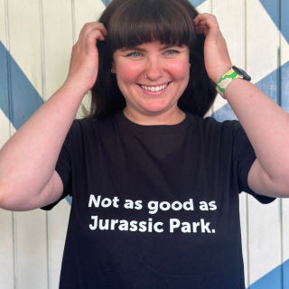 A model wearing one of our black 'Not as good as Jurassic Park' tees.