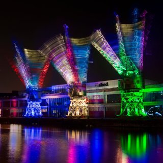 Photo colourfully list up cranes on Bristol Harbourside as part of Crane Dance by Guerilla Dance Project