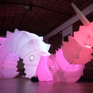A image of Luma a giant robotic pink lit-up snail.