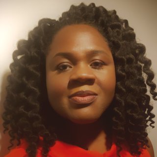 Head shot of a smiling woman wearing a red dress