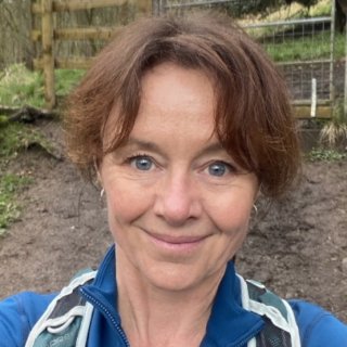 Head shot of smiling woman in a field