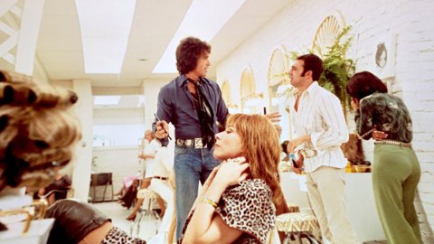 A photo of a hairdressing salon with people talking