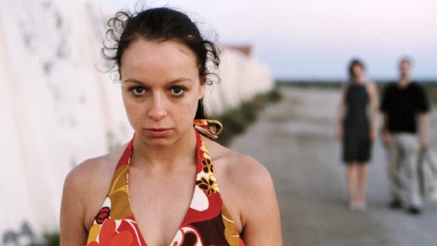 A photo of actress Samantha Morton in a coulrful top standing staring at the camera