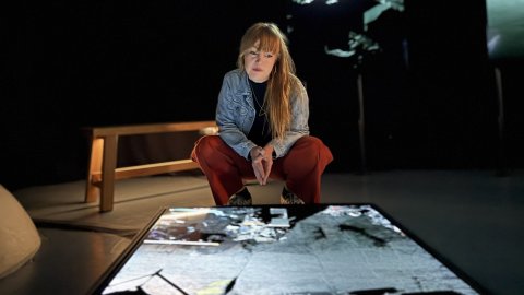 Amy Rose, Undershed Curator is peering down at a screen showing FRAMERATE: Pulse of the Earth