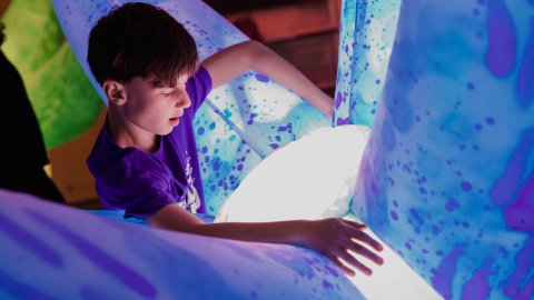 A child hugging a robotic inflatable