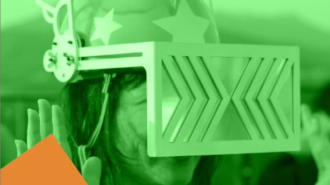 A person wearing a helmet with star designs and winged sides dons a futuristic visor in a green-tinted scene. Abstract shapes add a playful touch.