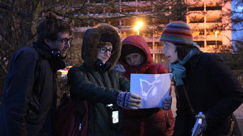 People exploring projected map in Give Me Back My Broken Night