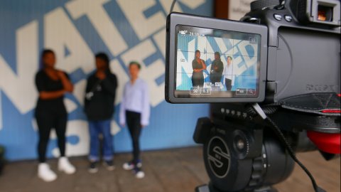Young people filming outside Watershed building