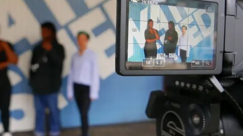 Young people filming outside Watershed building