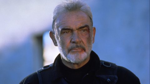 A still from The Rock. A man (Sean Connery), his face bruised and bloodied, stares into the middle distance, his brow furrowed.