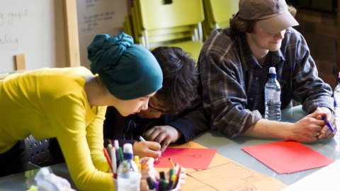 Three creatives collaborating at a workshop