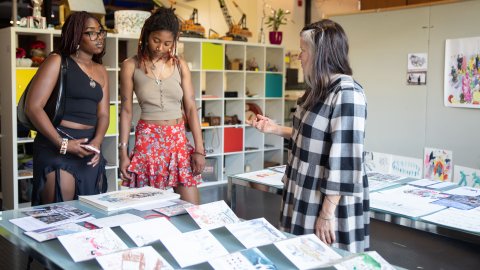 A photo of three people at First Friday in Watershed's Pervasive Media Studio.