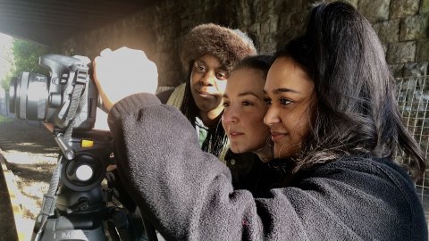 Young people looking at a camera