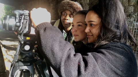 Three young people filming.