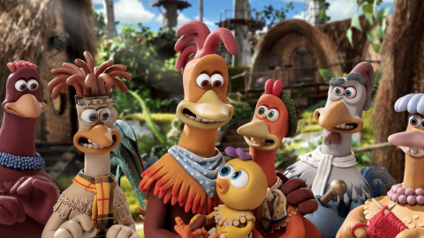 A still of a group of animated chickens, smiling at a baby chicken. 