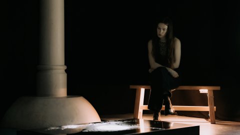 A picture of a person sitting in Undershed gallery.