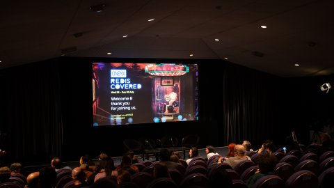 A cinema screen with the Cinema Rediscovered 2023 artwork on display.
