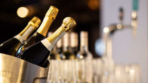 Bottles of prosecco in an ice cooler.