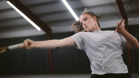 A young woman is playing tennis.