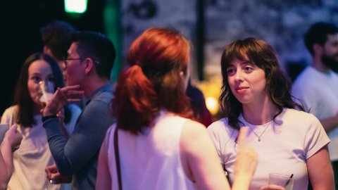 Two women in conversation at a networking event