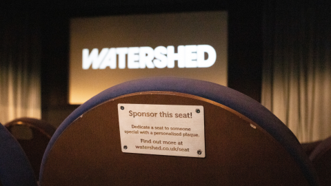 'Sponsor this seat' plaque on back of cinema seat