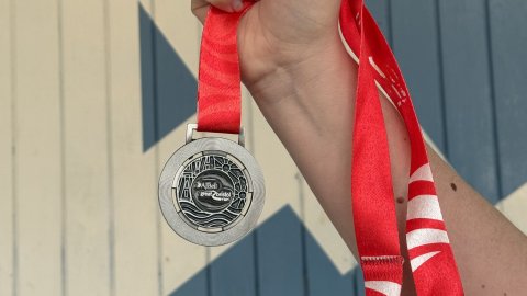 Hand holding medal from Great Bristol Run half marathon