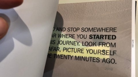Inside a notebook is some text on a grey page to help guide you through the audio walk.