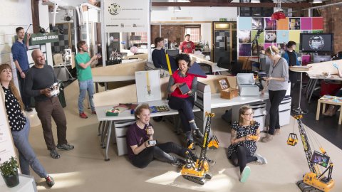 Residents of the PM Studio pose with bits of creative tech