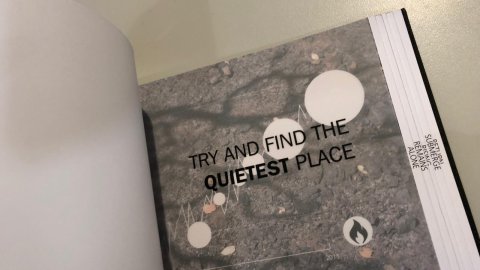 Inside a notebook is some text on a grey page to help guide you through the audio walk.