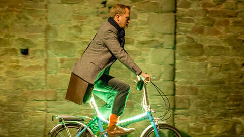 Man on illuminated bike