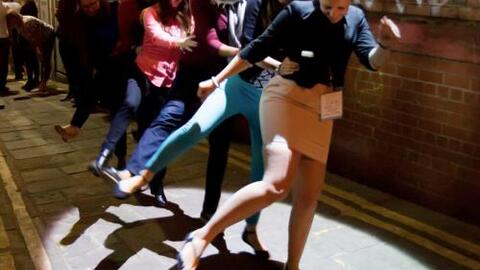 Girls dancing under a street lamp