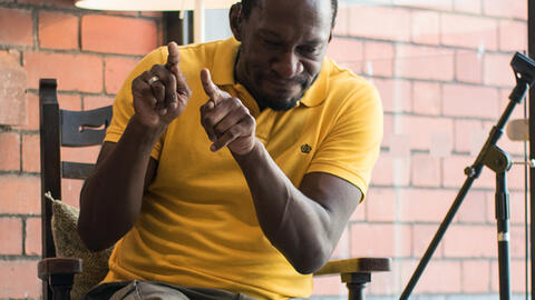 David Ellington, a Deaf Bristol artist and filmmaker, reading Matilda at last Friday's Read-in-a-day (Credit: Jon Aitken)