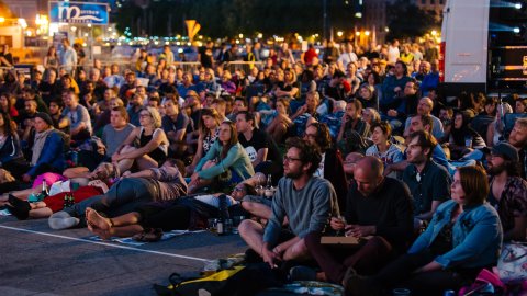 Seated audience at outdoor screening