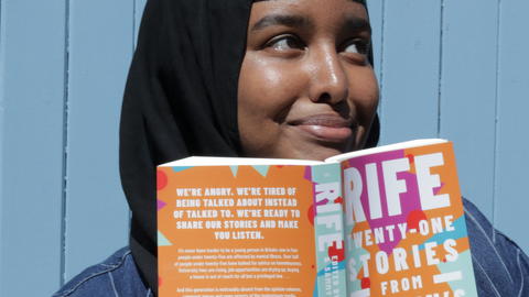 Woman smiling with open book