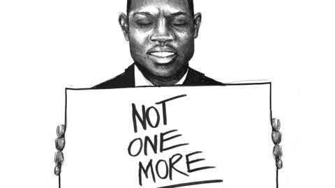 Black man holding a sign which says 'Not one more'.