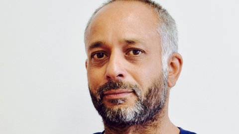 Head shot of Sidarth Sharma, Watershed Board member, with a grey beard, wearing a blue jumper.