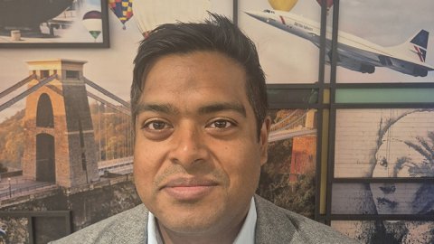 Head shot of a smiling man against a backdrop of pictures including, Concorde, hot air balloons and the Clifton Suspension Bridge