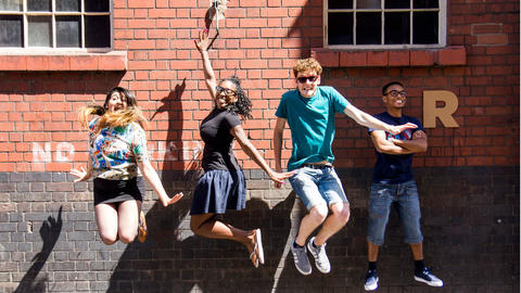 4 young people from Rife Magazine jumping in the air