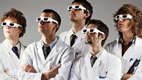 5 men in lab coats and 3d glassess looking up