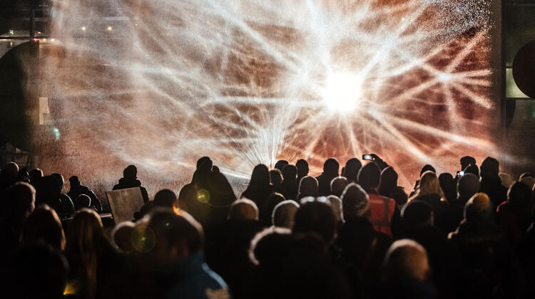 Photo of images of constellations projected onto a wall of waters as part of Watershed's Millennium Constellations commission