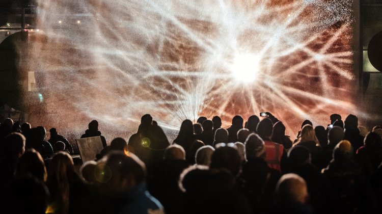 Photo of images of constellations projected onto a wall of waters as part of Watershed's Millennium Constellations commission